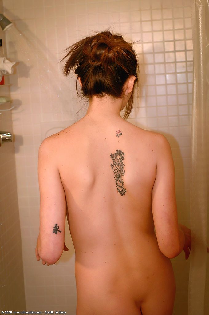 Amateur Latina babe with tattoos flaunting pierced nipples in shower