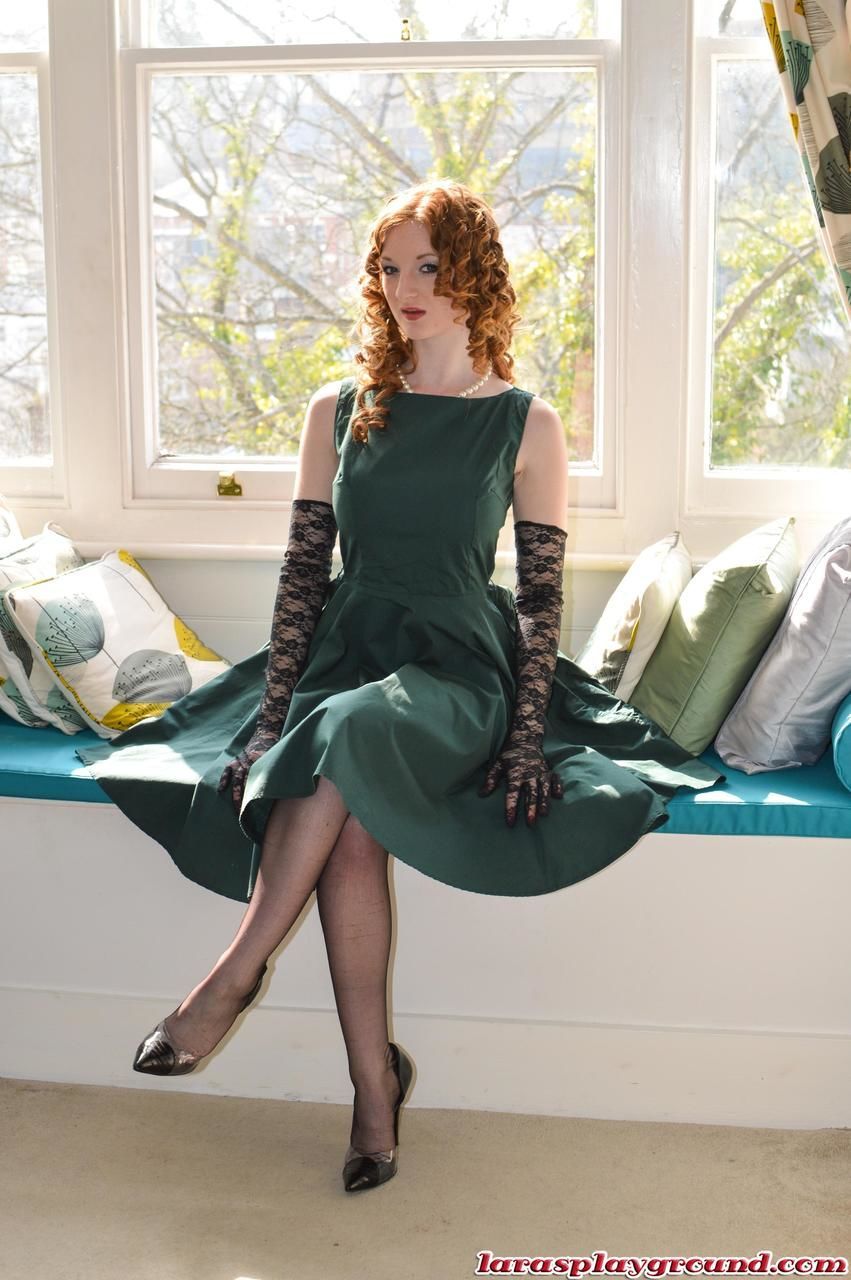Leggy MILF Lara Latex invites and redhead to pose with her by window in nylons