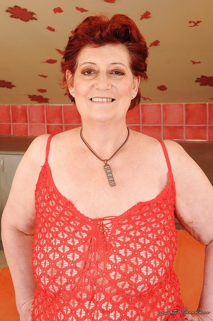 Fatty redhead granny with big flabby tits taking off her lingerie