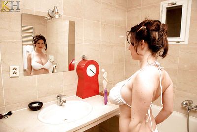 European MILF Karina Hart soaping up her massive tits in the bathtub
