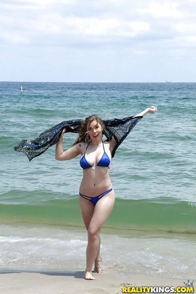 Beach babe Lena Paul freeing nice melons from bikini by swimming pool