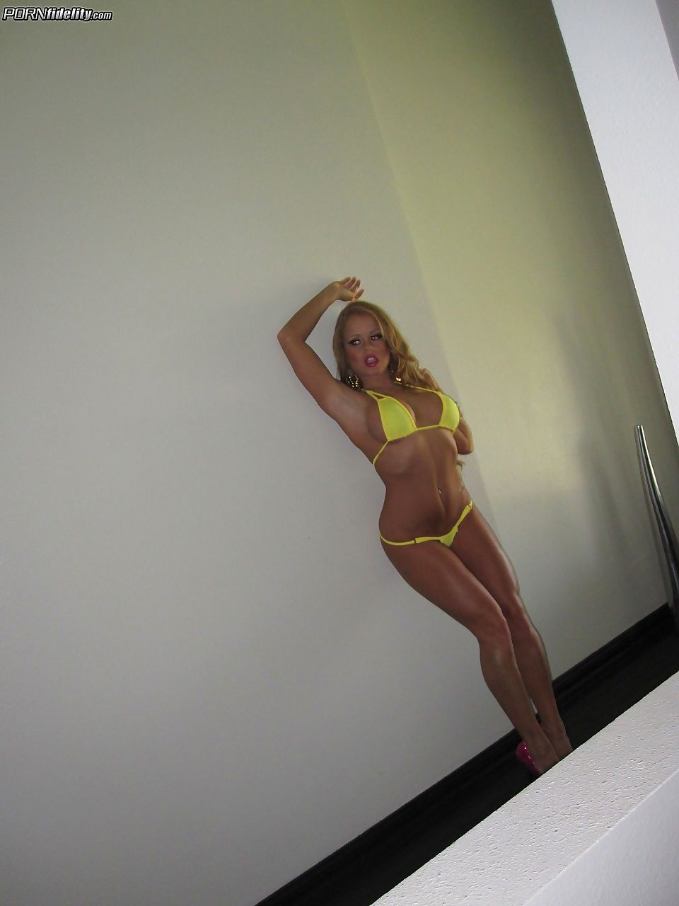 Blonde girl Nikki Delano changes into a bikini after arriving at the Madisons