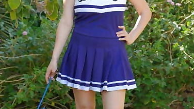 Cheerleader Danielle playfully..