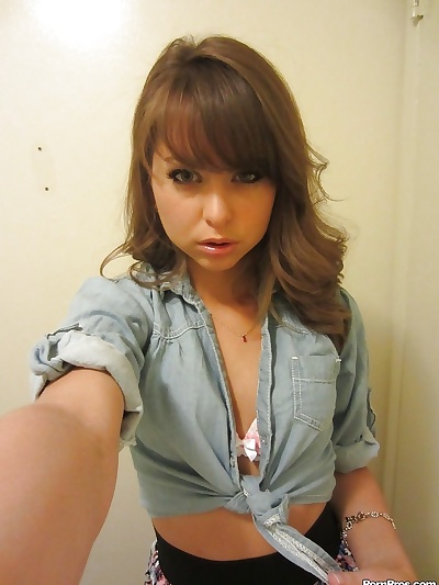 Clothed teen Riley Reid does some sexy self shots while in a toilet
